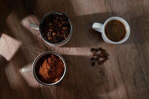 cups of coffee, phases of drink - bean, ground and empty cup. photo