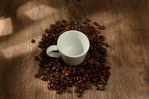 coffee cup and coffee beans on wooden background 2 photo