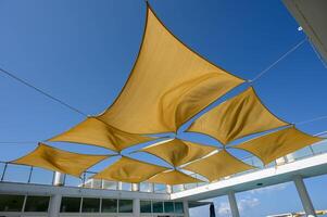 beach umbrellas against the blue sky Multiple large summer nylon patio sun shade umbrellas photo