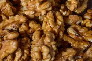 Many tasty walnuts as background, top view closeup of shelled organic walnut halves photo