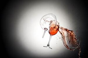 Collision of two wine glasses with splash photo