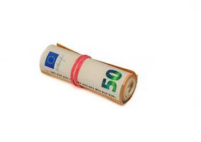 Roll of Euro bank notes, isolated on white, with a reflection underneath photo