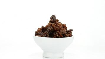 Raisins or dried grape rotating on white background video