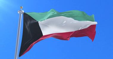 Flag of Kuwait waving at wind with blue sky in slow, loop video