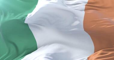 Irish flag waving at wind in slow in blue sky, loop video
