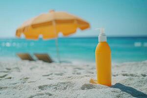 Sunscreen bottle on sandy beach with umbrella and blue sky background. Summer vacation concept photo