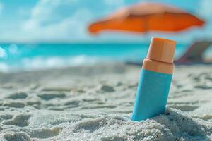 Sunscreen bottle on sandy beach with umbrella and blue sky background. Summer vacation concept photo