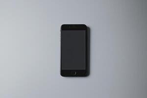 Smartphone with blank screen placed on background surface photo