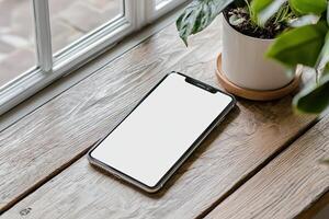 Smartphone with blank screen placed on background surface photo
