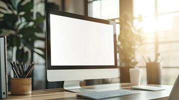 Close-up of a blank white screen computer monitor on a desk with office supplies in a minimalist home work space, front view, mockup template, soft blurred background, copy space concep photo