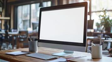 A white computer monitor close up on a table with copy space, a coffee mug, and a pen holder photo