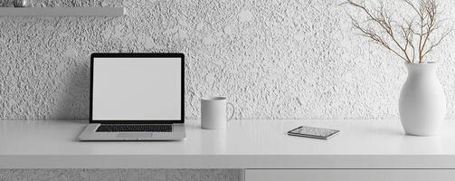 A clean, minimalist workspace featuring a laptop, smartphone, coffee mug, and decorative vase against a white brick wall photo