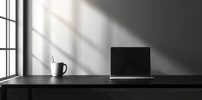 Laptop and coffee cup on black table in office. Workplace concept photo