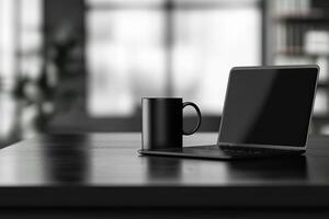 Laptop and coffee cup on black table in office. Workplace concept photo