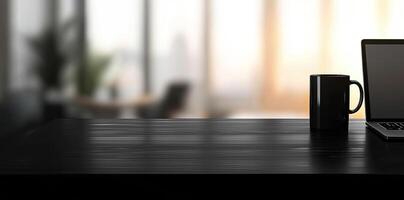 Laptop and coffee cup on black table in office. Workplace concept photo