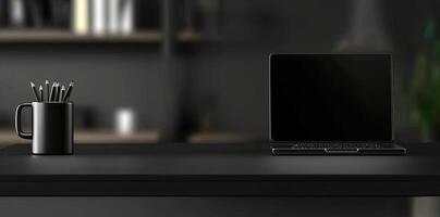 Laptop and coffee cup on black table in office. Workplace concept photo