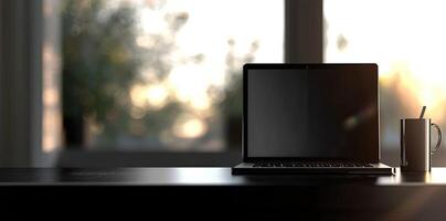 Laptop and coffee cup on black table in office. Workplace concept photo