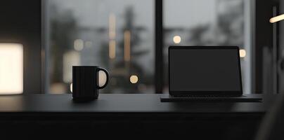 Laptop and coffee cup on black table in office. Workplace concept photo