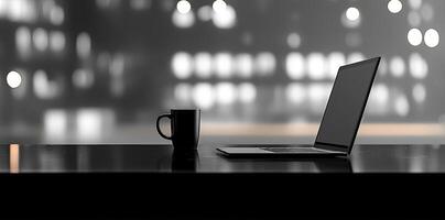 Laptop and coffee cup on black table in office. Workplace concept photo