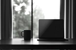 Laptop and coffee cup on black table in office. Workplace concept photo