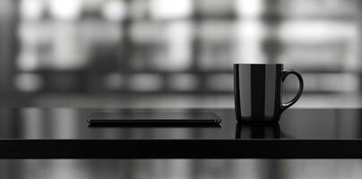 Laptop and coffee cup on black table in office. Workplace concept photo