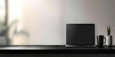 Laptop and coffee cup on black table in office. Workplace concept photo