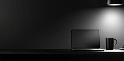 Laptop and coffee cup on black table in office. Workplace concept photo