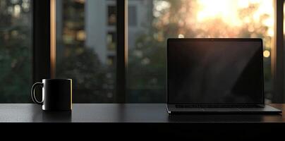 Laptop and coffee cup on black table in office. Workplace concept photo