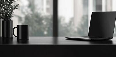 Laptop and coffee cup on black table in office. Workplace concept photo