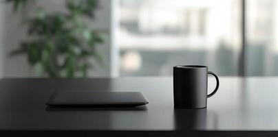 Laptop and coffee cup on black table in office. Workplace concept photo