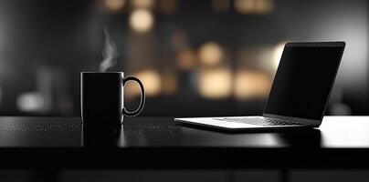 Laptop and coffee cup on black table in office. Workplace concept photo