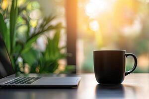 Laptop and coffee cup on black table in office. Workplace concept photo