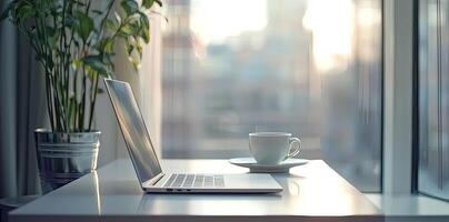 Blurred background of a modern home office interior with a laptop computer and a coffee cup on a white table, with copy space for text in the blurred window view. Business work from home concep photo