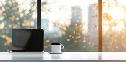 Blurred background of a modern home office interior with a laptop computer and a coffee cup on a white table, with copy space for text in the blurred window view. Business work from home concep photo