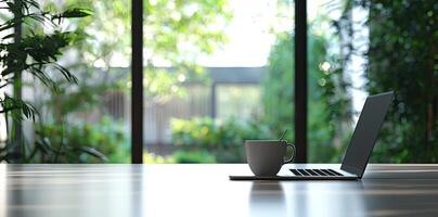 Blurred background of a modern home office interior with a laptop computer and a coffee cup on a white table, with copy space for text in the blurred window view. Business work from home concep photo