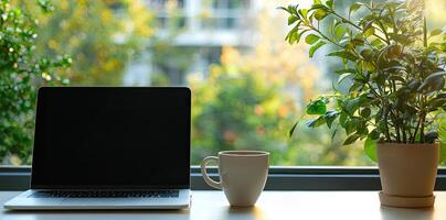 Blurred background of a modern home office interior with a laptop computer and a coffee cup on a white table, with copy space for text in the blurred window view. Business work from home concep photo