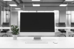 Minimalist white desk with a computer and office background, blurred business center interior in the blurred background. Mockup for design or presentation photo