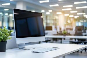 Minimalist white desk with a computer and office background, blurred business center interior in the blurred background. Mockup for design or presentation photo