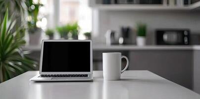 Minimalist white office desk with laptop and coffee mug on a blurred background, with space for text, representing the concept of working from home photo