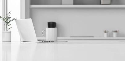 Minimalist white office desk with laptop and coffee mug on a blurred background, with space for text, representing the concept of working from home photo