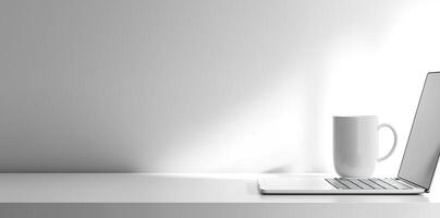 Minimalist white office desk with laptop and coffee mug on a blurred background, with space for text, representing the concept of working from home photo
