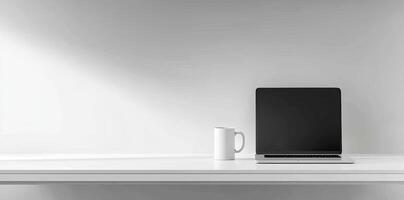 Minimalist white office desk with laptop and coffee mug on a blurred background, with space for text, representing the concept of working from home photo