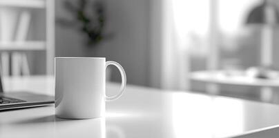 Minimalist white office desk with laptop and coffee mug on a blurred background, with space for text, representing the concept of working from home photo