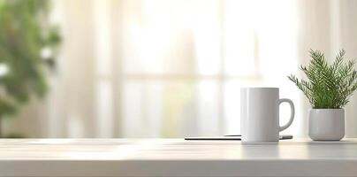 Minimalist white office desk with laptop and coffee mug on a blurred background, with space for text, representing the concept of working from home photo
