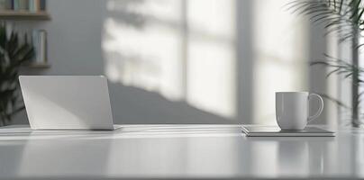 Minimalist white office desk with laptop and coffee mug on a blurred background, with space for text, representing the concept of working from home photo