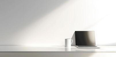 Minimalist white office desk with laptop and coffee mug on a blurred background, with space for text, representing the concept of working from home photo