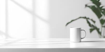 Minimalist white office desk with laptop and coffee mug on a blurred background, with space for text, representing the concept of working from home photo