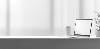Minimalist white office desk with laptop and coffee mug on a blurred background, with space for text, representing the concept of working from home photo