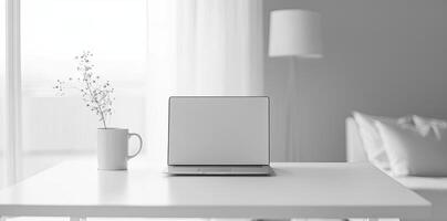 Minimalist white office desk with laptop and coffee mug on a blurred background, with space for text, representing the concept of working from home photo