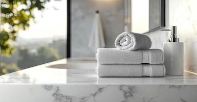 Neatly folded white towels on a marble countertop in a minimalist, luxurious bathroom with soft lighting and stylish decor photo